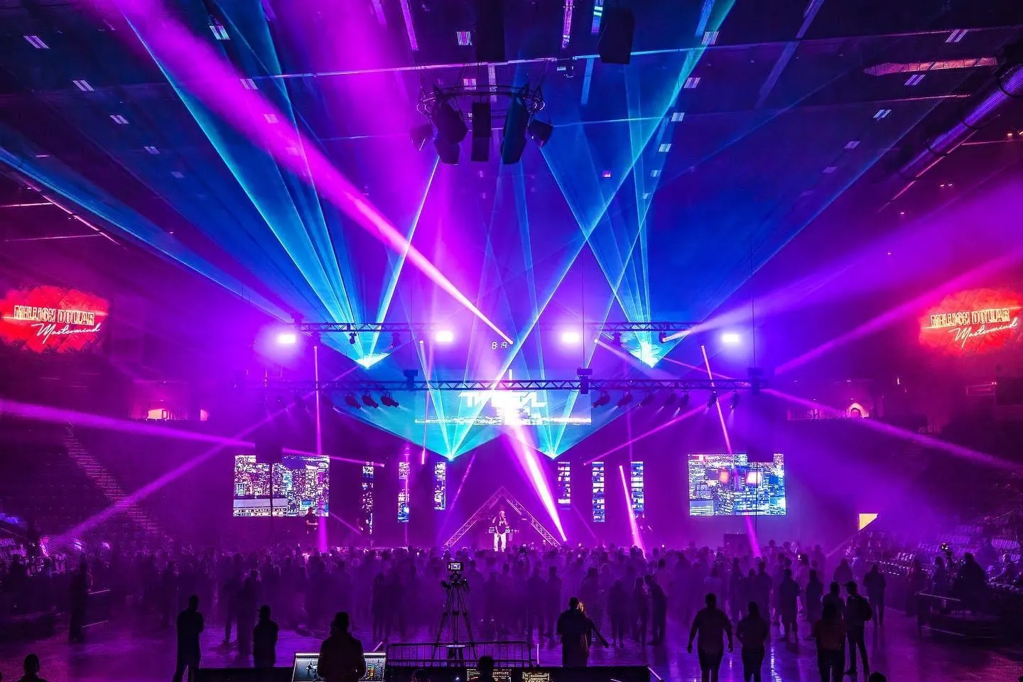 Purple and blue lasers over a live audience