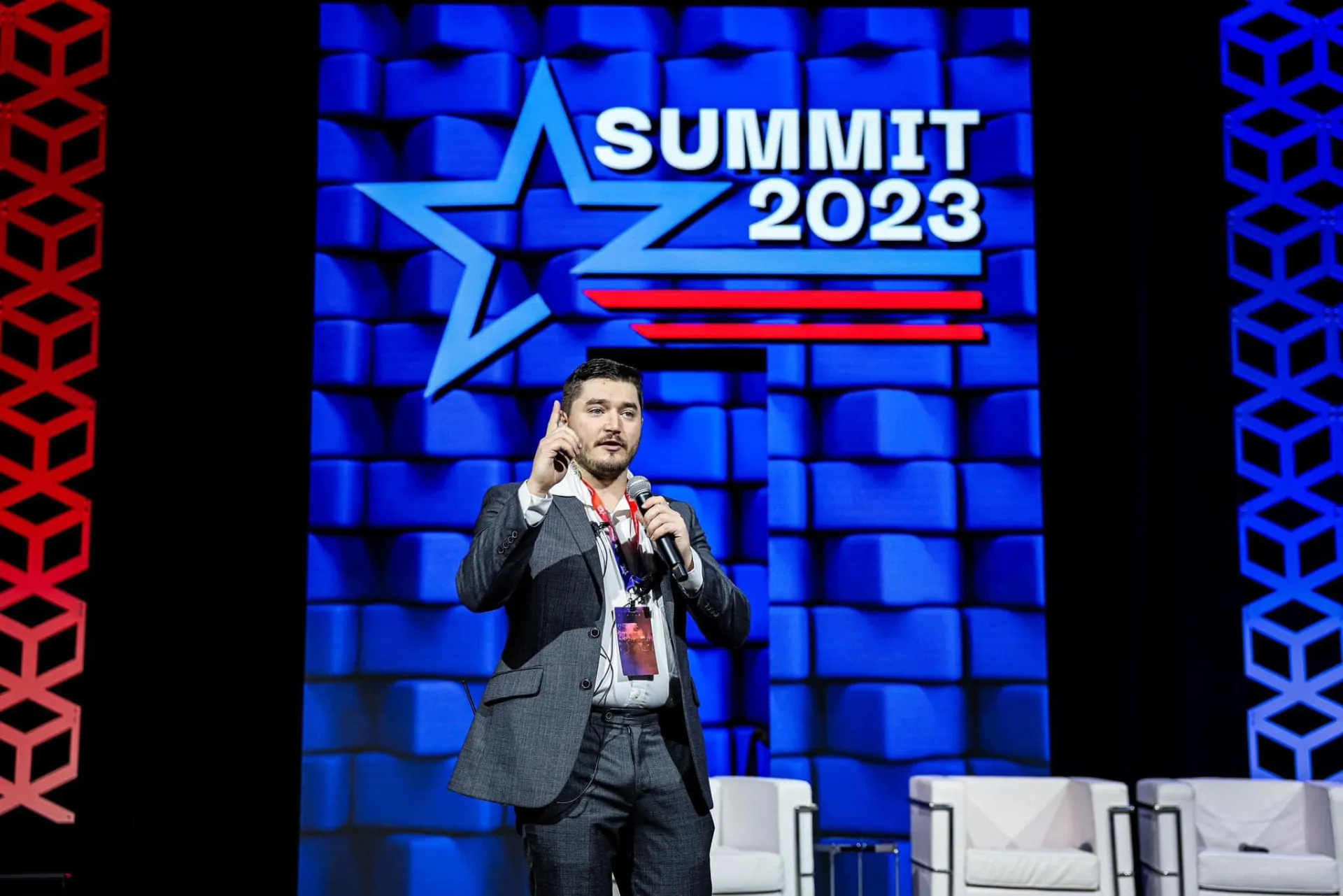 Speaker addressing the summit audience from the main stage